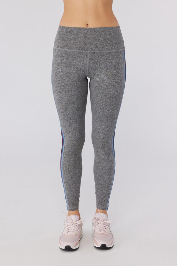 Female model wearing gray leggings with pink running shoes