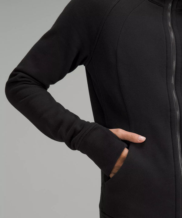 Female model wearing black full zip hoodie with her hand in her pocket