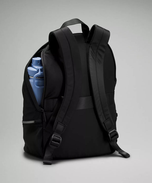 Black backpack partially unzipped with blue water bottle poking out