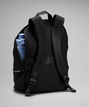 Load image into Gallery viewer, Black backpack partially unzipped with blue water bottle poking out