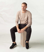 Load image into Gallery viewer, male model wearing black athletic jogger pants sitting on a wooden box