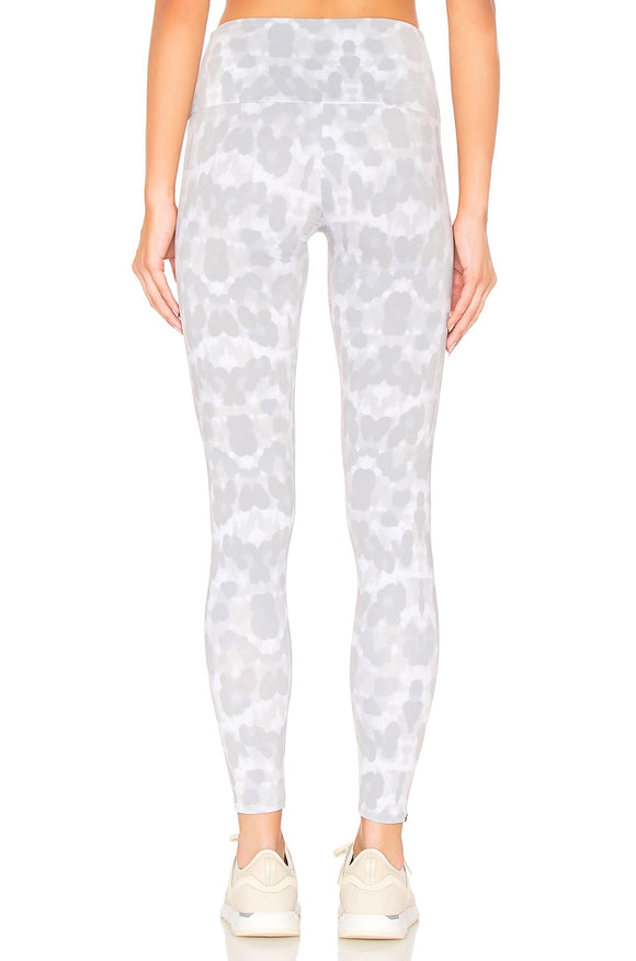 Female model wearing nocturnal leopard print gray leggings from Onzie