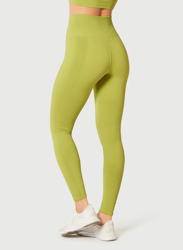 Female model wearing pear colored leggings from Nux Activewear