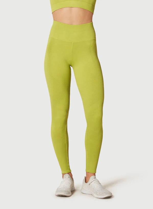Female model wearing pear colored leggings from Nux Activewear