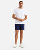 male model wearing navy blue athletic shorts  and white t-shirt