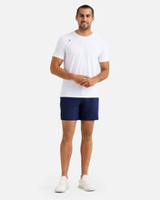 Load image into Gallery viewer, male model wearing navy blue athletic shorts  and white t-shirt