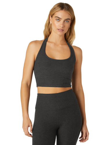 Woman wearing Beyond Yoga Darkest Night halter top and darkest night yoga leggings. 