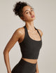 Woman wearing Beyond Yoga Darkest Night halter top and darkest night yoga leggings. 