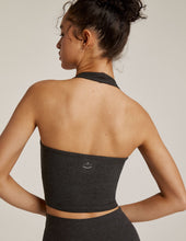Load image into Gallery viewer, Back of Woman wearing Beyond Yoga Darkest Night halter top and darkest night yoga leggings. 