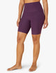 female model wearing purple twilight biker shorts from beyond yoga