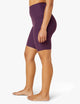 female model wearing purple twilight biker shorts from beyond yoga