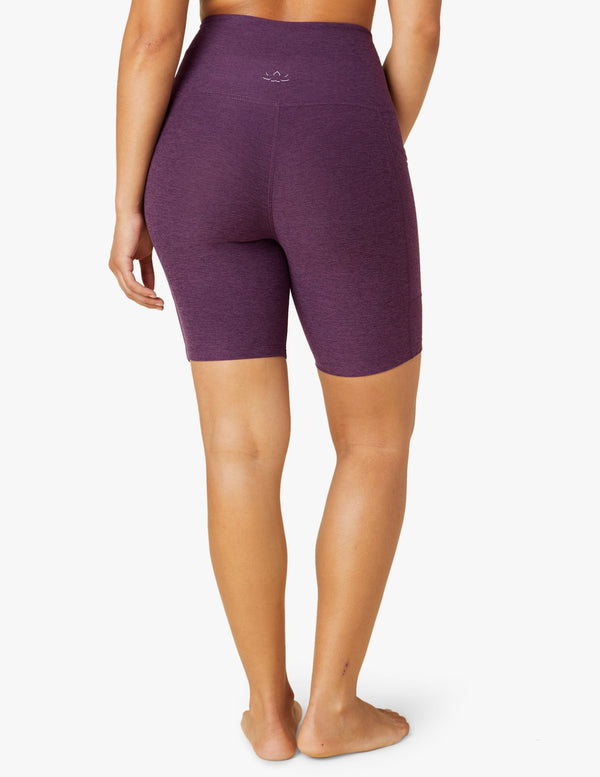 female model wearing purple twilight biker shorts from beyond yoga