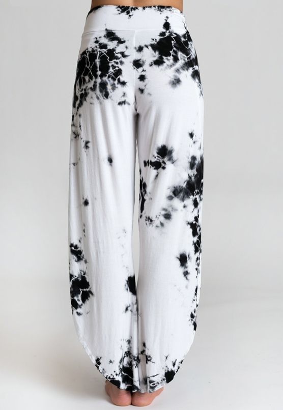 Female model wearing black and white tie dye loose pants from Jala Clothing