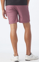 Man wearing mauve shorts from Glyder with white sneakers.