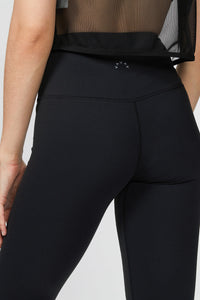 Female model wearing black Nita leggings from Varley