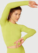 Female model wearing pear colored long sleeve from Nux Active Clothing