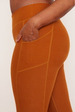 Load image into Gallery viewer, Female model wearing orange pocket legging from wolven