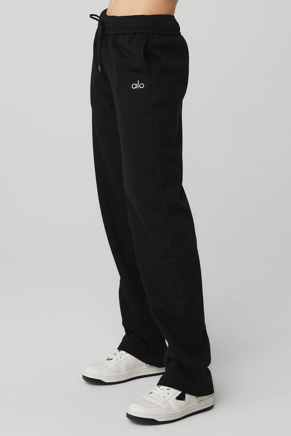Female model wearing loose black sweatpants