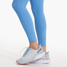 Load image into Gallery viewer, Close up of blue vuori leggings and hoka sneakers. 