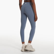 Load image into Gallery viewer, back view of a woman wearing blue yoga leggings and white sneakers
