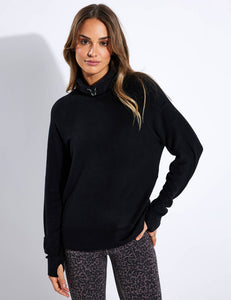 Female model wearing black addisson sweatshirt from varley