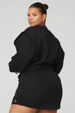 Load image into Gallery viewer, Black female model wearing black Alo Yoga pullover coverup and matching skirt