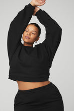 Load image into Gallery viewer, Black female model wearing black Alo Yoga pullover coverup and matching skirt