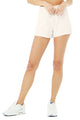 Female model wearing ivory lounge shorts from Alo Yoga