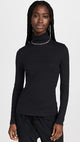 Female model wearing essential ribbed turtleneck from beyond yoga