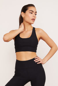 Female model wearing black sports bra from Wolven