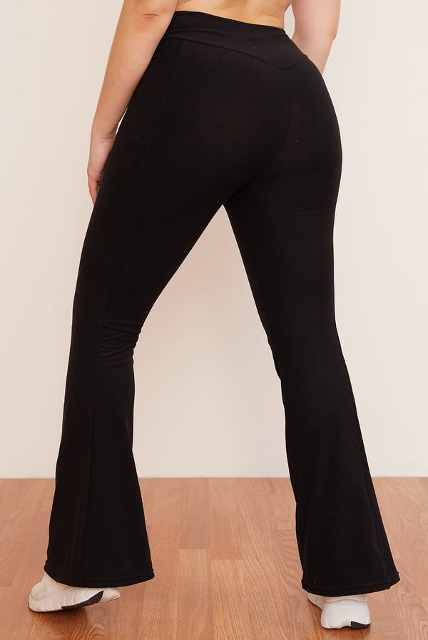 Female model wearing black flare pant from wolven