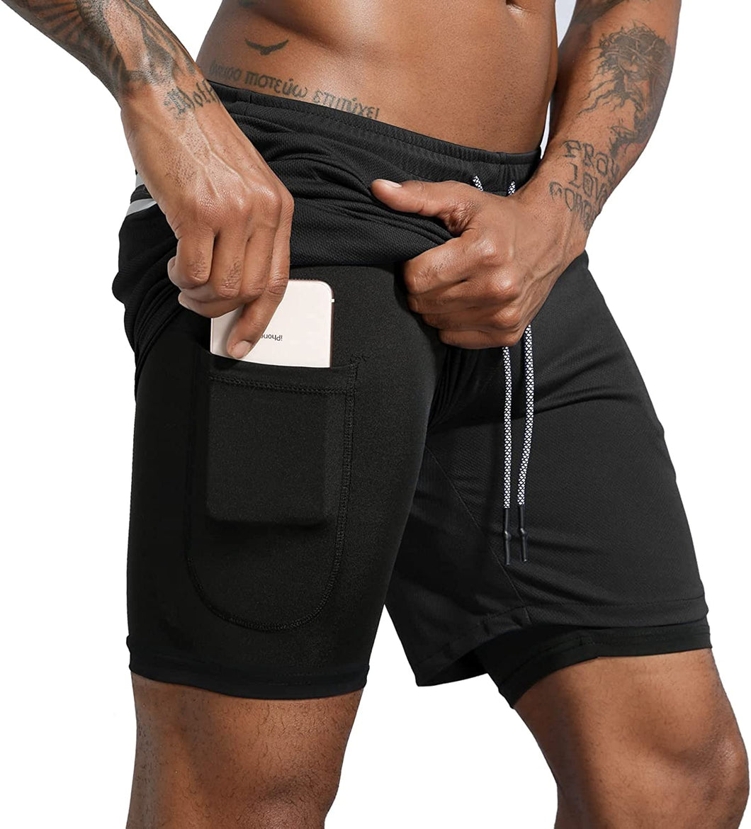 black male model pulling a phone out of his black athletic shorts