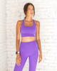 Female model wearing bright purple sports bra from kosha fit