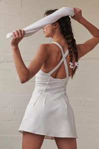 Female model wearing white tennis skort dress from free people