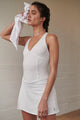 Female model wearing white tennis skort dress from free people