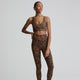 Female model wearing bronzed cheetah leggings from Varley
